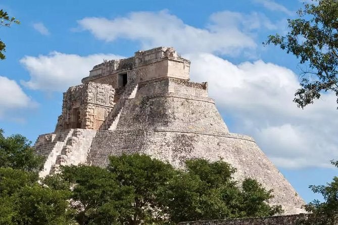 The Pyramid of the Magician at Uxmal, its rounded sides rising above the trees